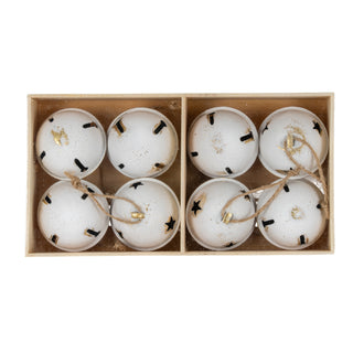 Eight white distressed metal bells packed neatly inside a light wooden box with a central divider.