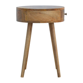 Circular wooden nightstand with three tapered legs and a single drawer featuring a small brass knob.