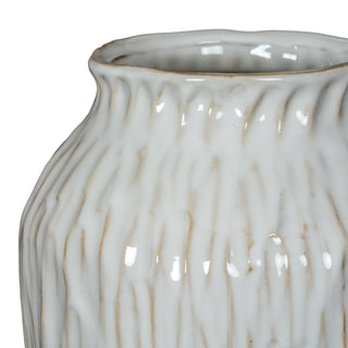 Detail shot of the glossy white ceramic surface showing the irregular vertical texture and brown undertones.