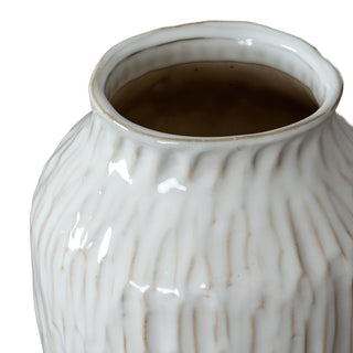 Close-up detail of the vase rim showing the uneven edge, glossy white glaze, and the contrasting brown interior.