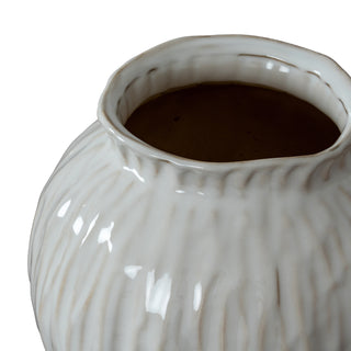 Detail shot showing the glossy glaze, textured vertical ridges, and irregular rim of the ceramic vase.