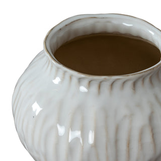 Close-up showing the irregular, rustic rim and the glossy white, vertically textured surface of the vase.