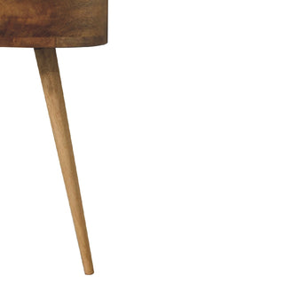Detail shot of the bedside table's tapered wooden leg attaching beneath the circular body.