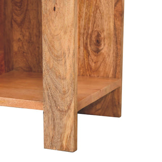 Detail of the nightstand base and leg structure, highlighting the rich wood grain and knot on the vertical panel.