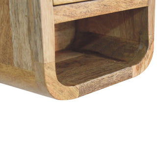 Close detail of the curved internal base of the open storage slot, showing the wood grain and rounded edges.