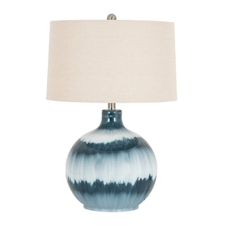 Front view studio shot of the table lamp, highlighting the blue and white dip-dyed glazed ceramic base and linen shade.