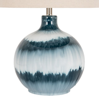 Detail view of the glossy ceramic base with vertical streaks of deep blue and white glaze.