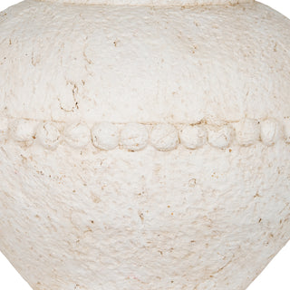 Detail of the vase's rough, off-white surface texture and the decorative band of raised, round elements.