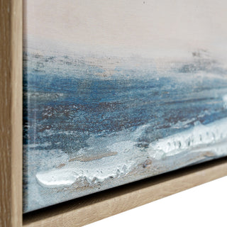 Close-up showing the thick white impasto paint texture on the blue canvas surface, meeting the pale wood frame edge.