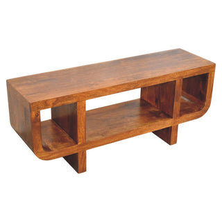 High-angle view of the curved chestnut media unit, showing the top surface, internal cubbies, and cross-shaped supports.
