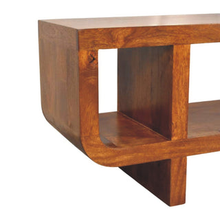 Close-up of the rounded corner joint of the chestnut media unit, showing the thick construction and internal divider.