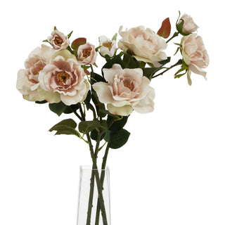 Multiple artificial tea rose stems arranged in a clear glass vase against a white background.
