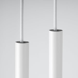 Pair of white cylindrical pendant tops showing the fine texture, silver rim, and braided white cable.