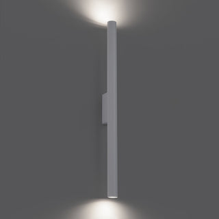 Up and down lighting effect from the illuminated white cylindrical wall lamp.