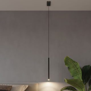 Single black cylindrical pendant light suspended above a bed, casting a focused downward beam.