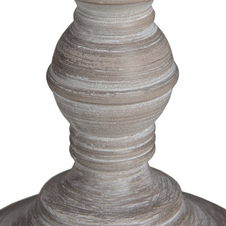 Detail of the turned wooden base showing the distressed grey paint and visible brushstrokes.