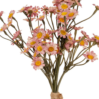 Close-up detail of the artificial pink daisy blooms showing pink petals and bright yellow centres.