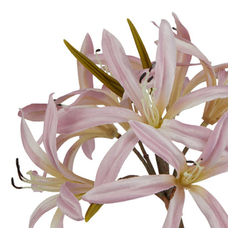 Close-up detail of the artificial pink lily blooms showing petals, stamens, and texture.