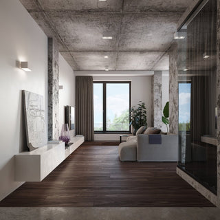 Multiple quad ceiling lamps installed on a concrete ceiling in a modern living room setting.