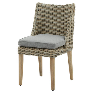 Studio shot of a woven grey rattan dining chair with wooden legs and a light grey cushion.