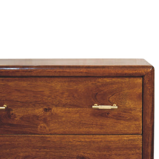 Close-up of the polished dark wood top and rounded corner edge of the chest.
