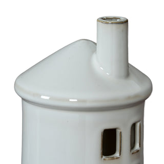 Close-up of the glazed white ceramic lighthouse roof and chimney. Detail shows the distressed finish around the rim and windows.