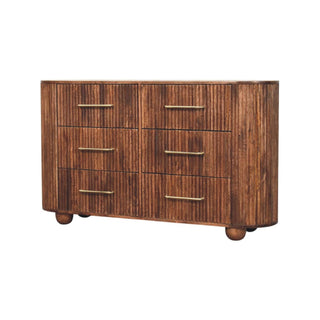 Three-quarter view of the six-drawer chest with ridged fronts, brass bar handles, and spherical wooden feet.