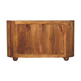 Straight-on view of the amber oak chest showing the natural wood grain and knots on the main body, framed by vertical ridges.