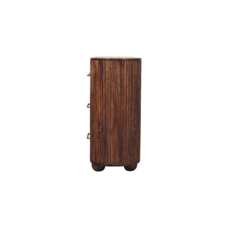 Full side profile of the ridged chest of drawers with spherical feet and brass handles.