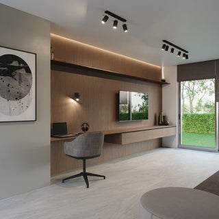 Two black multi-spot ceiling light bars installed in a modern home office with wood panelling and tiled floor.