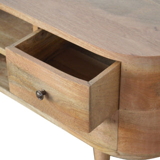 Detail of the rounded wooden unit showing a partially open drawer, its interior, and a small metal knob.