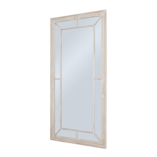 Tall rectangular mirror with distressed whitewash frame, photographed from a three-quarter angle.