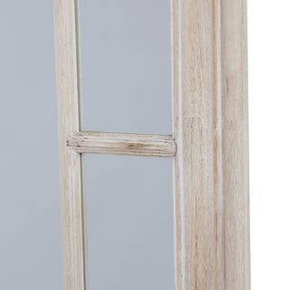 Close-up showing the fluted profile of the whitewashed frame and the horizontal window pane divider.