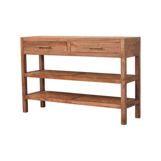 Wooden console table with two drawers, brass handles, and two lower shelves. Rattan panels inset into the shelves and top surface.