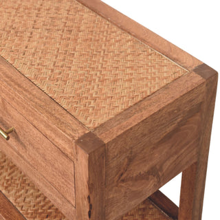 Close-up of the console's wooden frame, showing the corner joint, woven rattan inlay, and brass drawer handle.