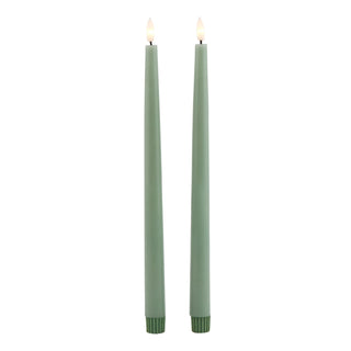 Pair of sage LED dinner candles, highlighting the ribbed, darker green base sections.