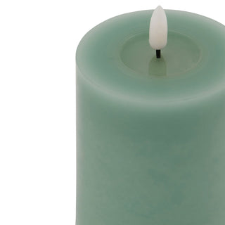 Close-up detail of the sage wax pillar candle showing the LED flame element and wax texture.