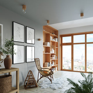 Interior room scene with natural wood fixtures (like the lamp base) used as ceiling and wall lights.