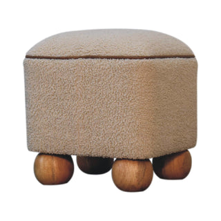 Serenity footstool, beige boucle fabric body with brown piping, resting on four wooden ball feet.