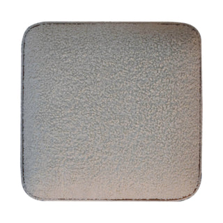 Full overhead view of the square beige boucle footstool surface with brown piping detail.