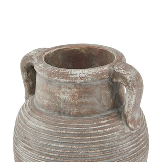 Close detail of the brown ceramic amphora pot showing the ridged texture and handles near the rim.