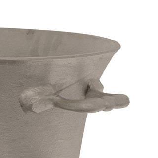 Close-up showing the silver metal cooler's rough texture, flared rim, and small side handle.
