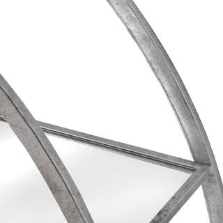 Close up of the distressed silver metal frame and the edge of a mirrored shelf.