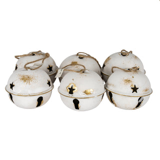 Close up of six distressed white bells showing gold paint flecks, star and keyhole cutouts.