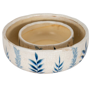 Two ceramic bowls, the smaller one nested inside the larger, showing the crackled cream interior.