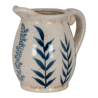 Cream ceramic jug with blue flora pattern and crackle glaze texture, three-quarter view.