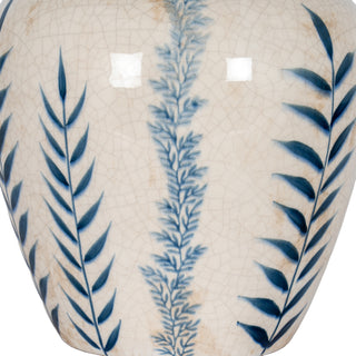 Detail of cream crackle glaze and blue painted patterns: dense fern motif next to simple leaf design.