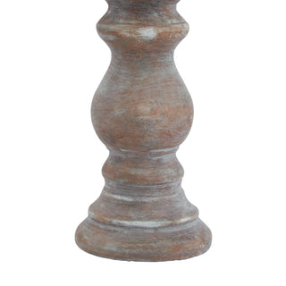 Close detail of the turned base and lower stem of the ceramic candle holder.