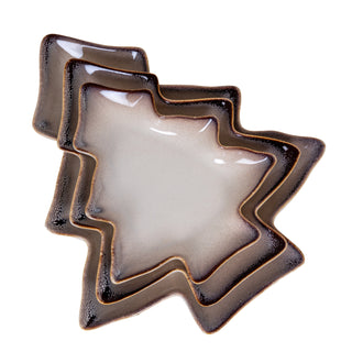 Three pale grey ceramic tree dishes stacked askew, showing the glossy glaze and dark brown mottled rims.