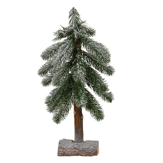 Small artificial pine tree with flocked green needles, standing on a snow-dusted wooden log base.